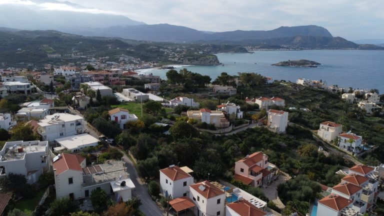 Aerial drone view of an off-plan residential project in Plaka with panoramic sea and mountain views