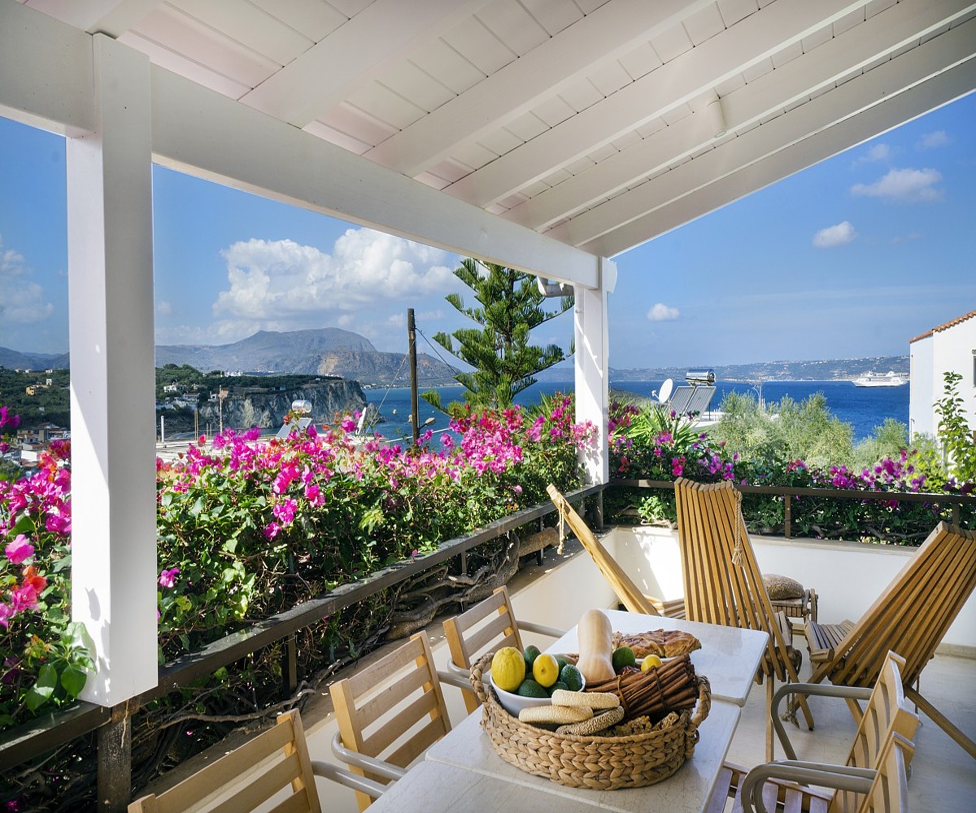 Seaside boutique property in Almyrida, Chania with landscaped garden, private terraces, and panoramic views of the bay and White Mountains