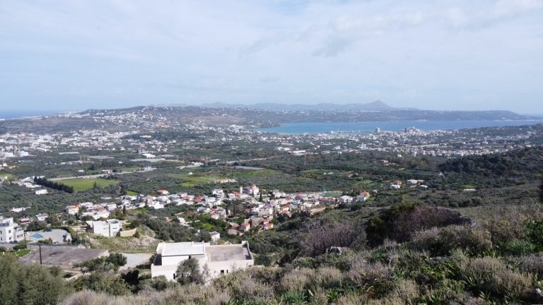 Panoramic sea and mountain landscape from hillside plot near Chania