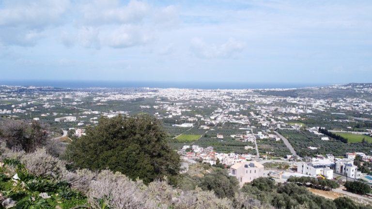 Scenic panoramic landscape from hillside plot in Malaxa with mountain and coastline views