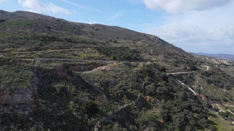 Distant drone view of land plot for sale in Malaxa, Crete