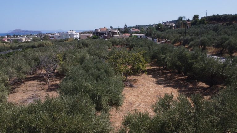 Drone perspective of coastal plot in Maleme Chania with views toward the sea and village