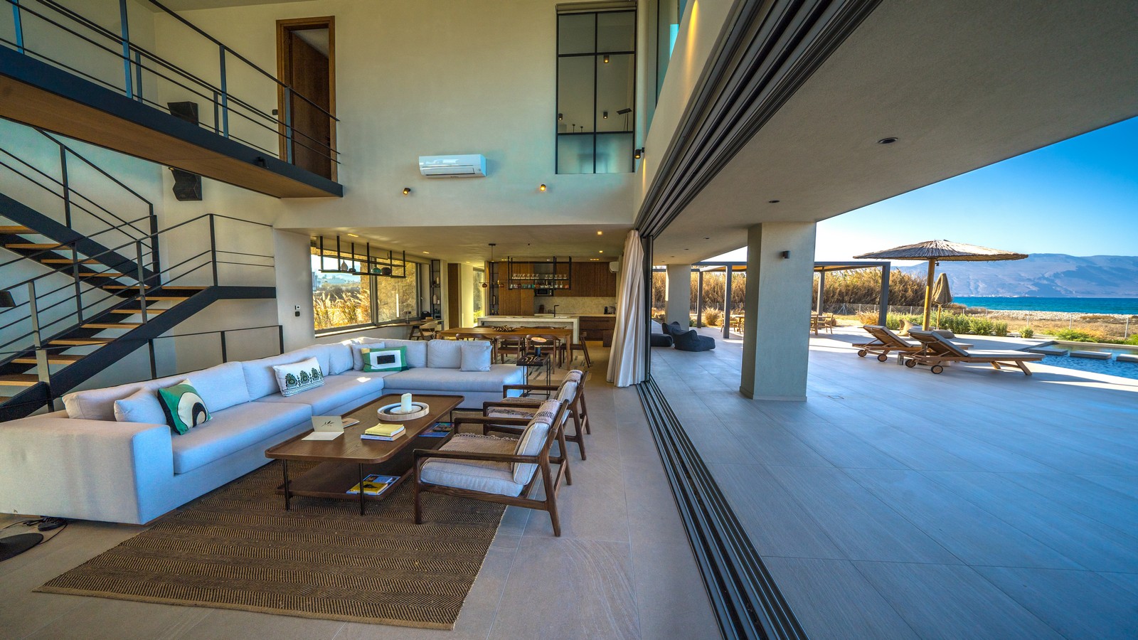 Indoor outdoor living space in a modern villa in Crete with sliding glass doors