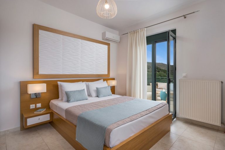 Double bedroom in Afrata with balcony doors leading to a stunning view