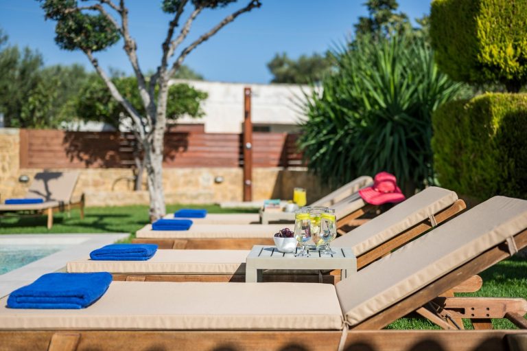 Sunbathing area in property for sale next to private pool in beautiful garden