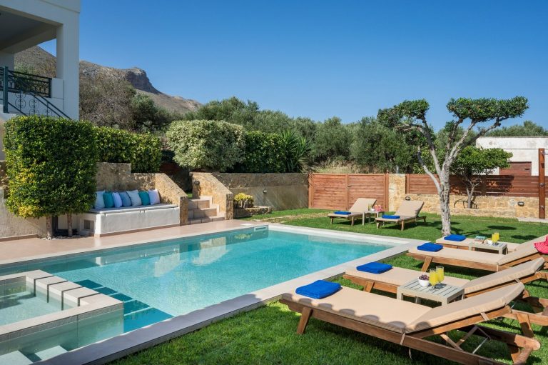 Photo of exterior of villa for sale in Afrata with beautiful garden and private swimming pool