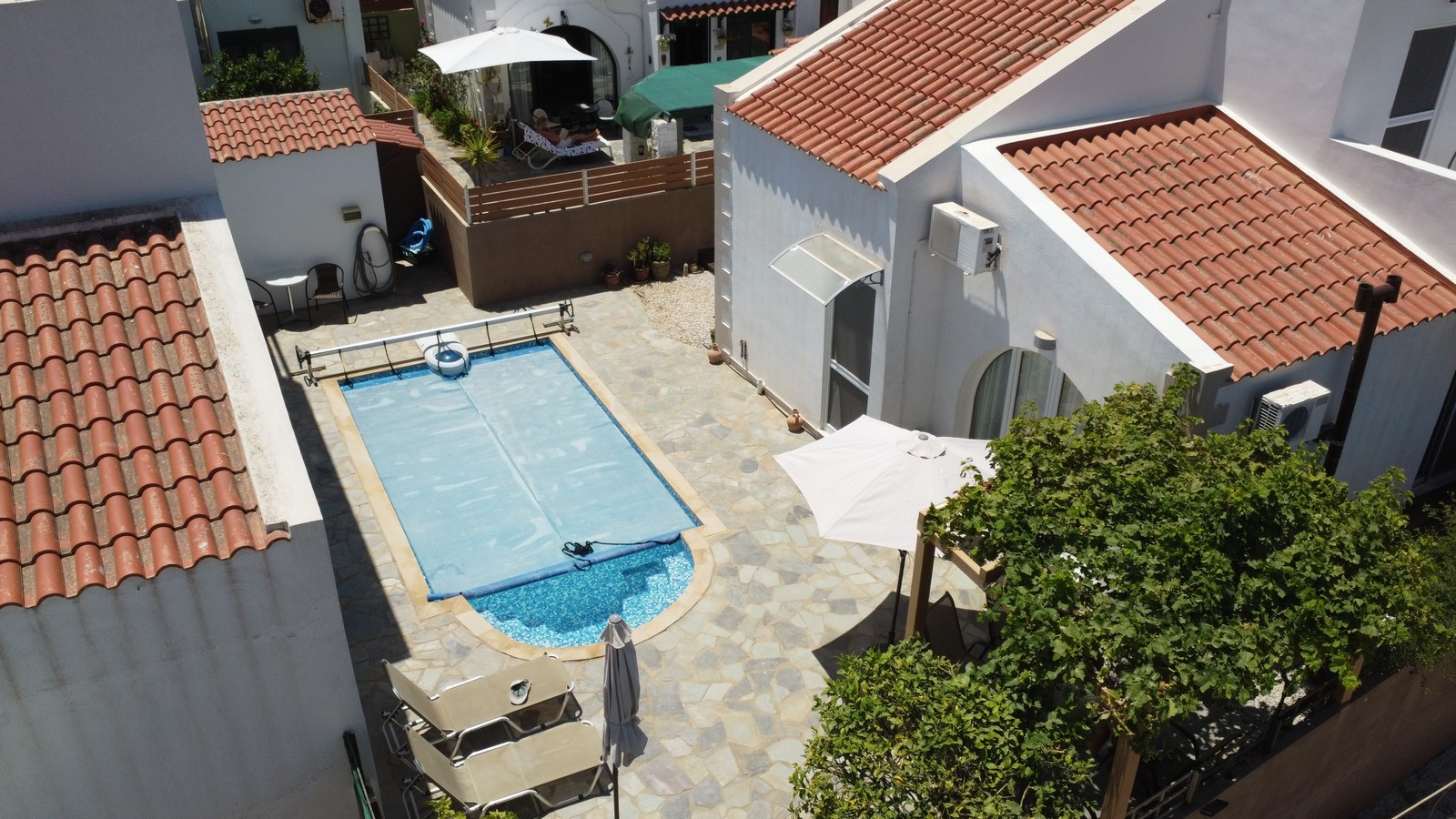 Drone pfoto of the property in Kalidonia for sale showcasing paved terrace and pool