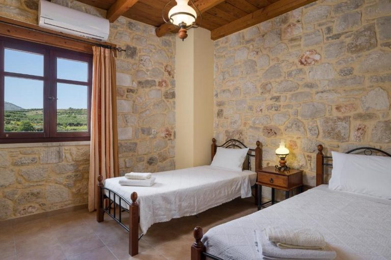 Cozy bedroom in Crete villa overlooking olive groves and rural landscape