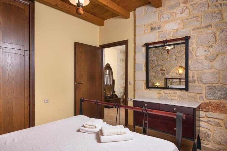 Cozy bedroom in traditional stone home with rustic design near Falassarna
