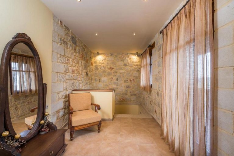 Charming bedroom in stone property overlooking gardens and rolling Cretan hills