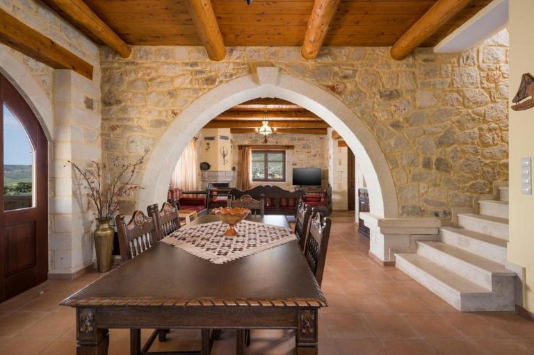 Rustic stone villa kitchen in Crete with modern appliances and wooden details