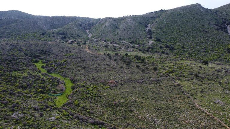 Expansive Aerial View of Rural Plot with Ocean and Mountain Vistas