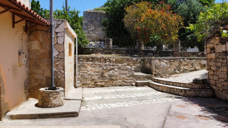 stone details on the exterior and well on property for sale in kalamitsi amigdalou