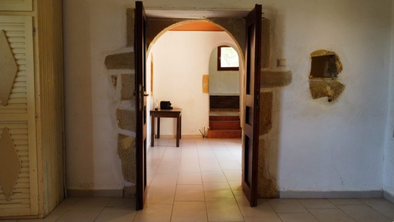 arched stone door leading to a bedroom property for sale in crete