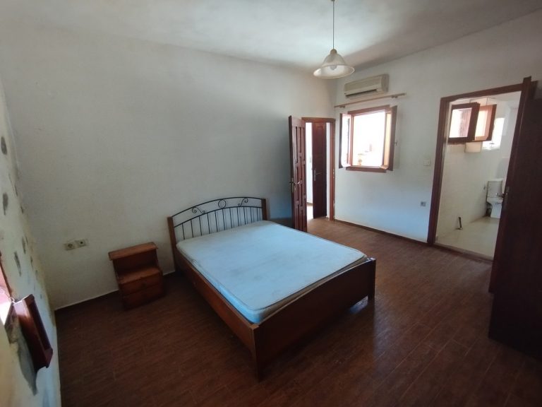 double bedroom in character stone home with venetian design influences in apokoronas
