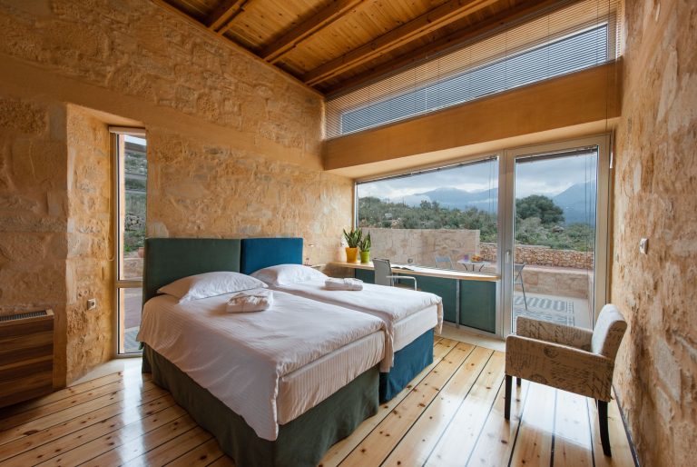 Cozy Wooden Bedroom with Windows Overlooking the Cretan Landscape